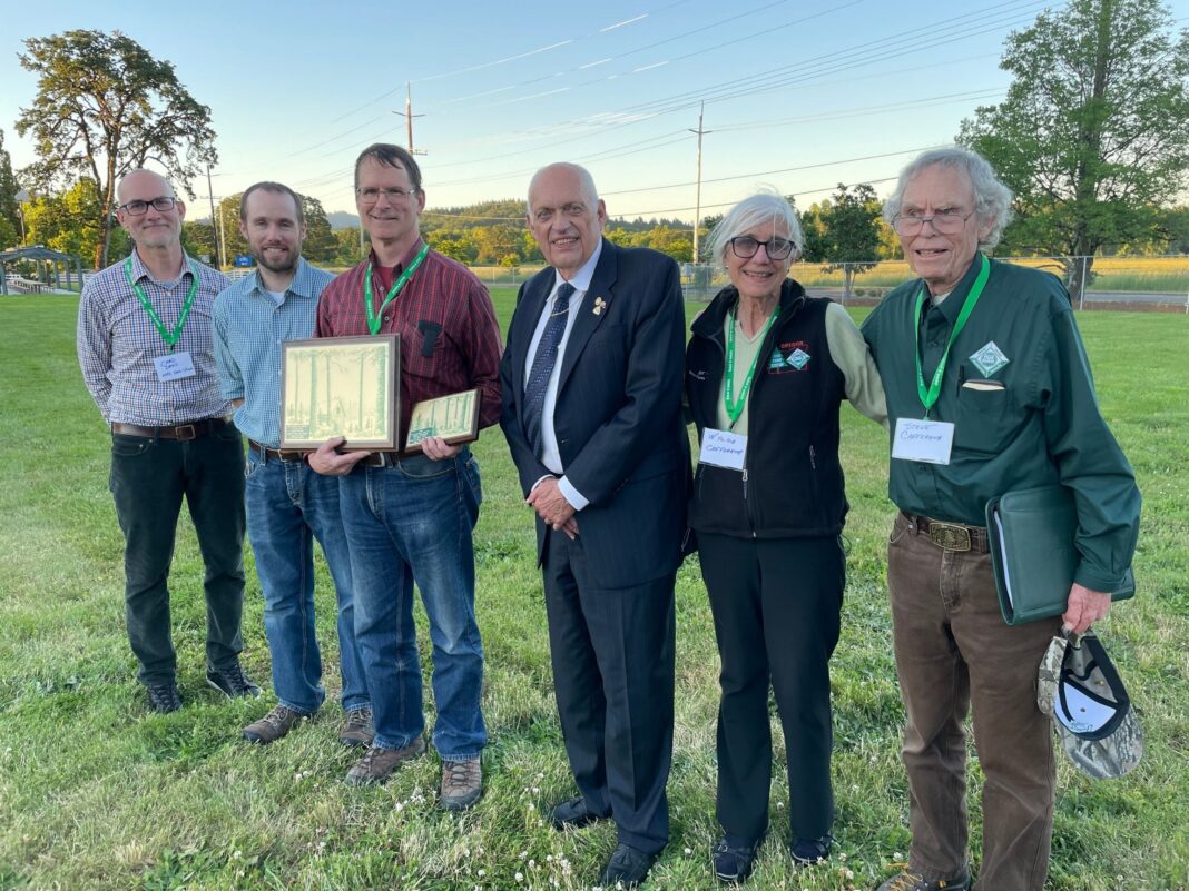 david bugni oregon tree farmer of the year group photo with plaque