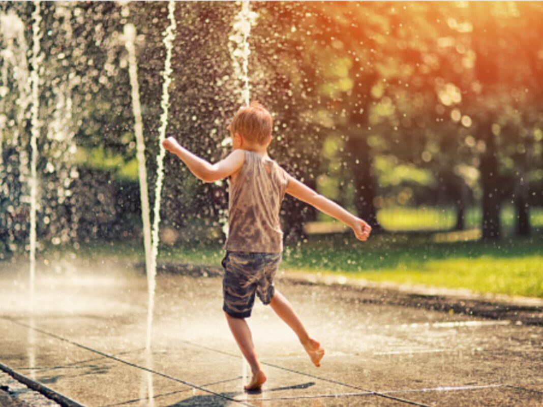 child_playing_fountain_cooling_down