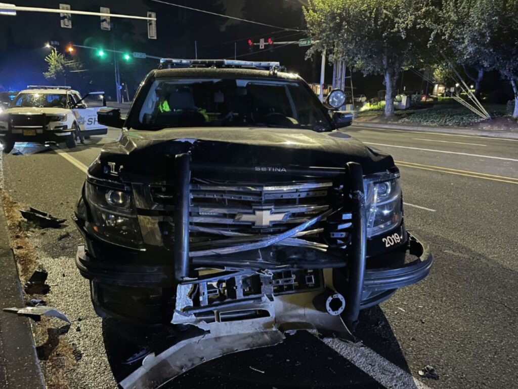 Damaged Patrol car officer involved crash with black sedan