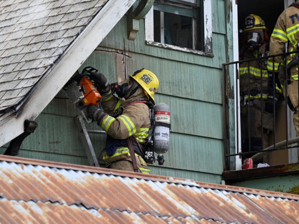 firefighter on top of roof triplex sherwood