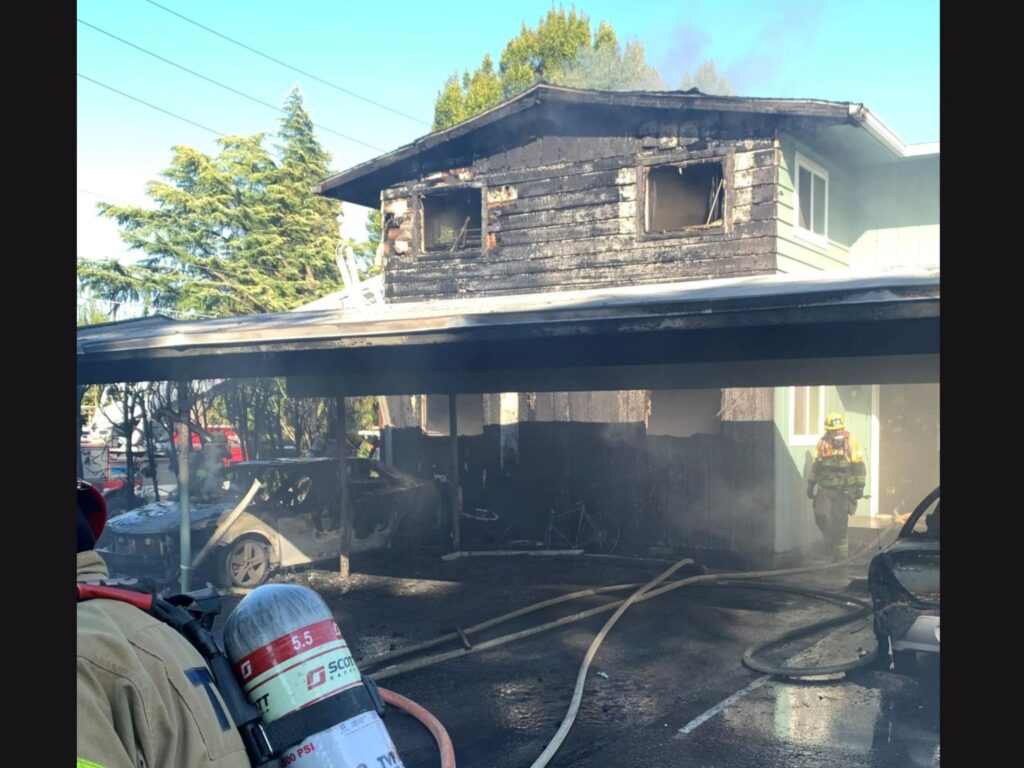 side of burned house and burned car beaverton