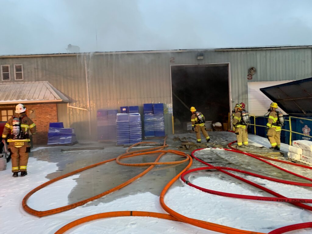 tvfr at commercial building fire hoses at front