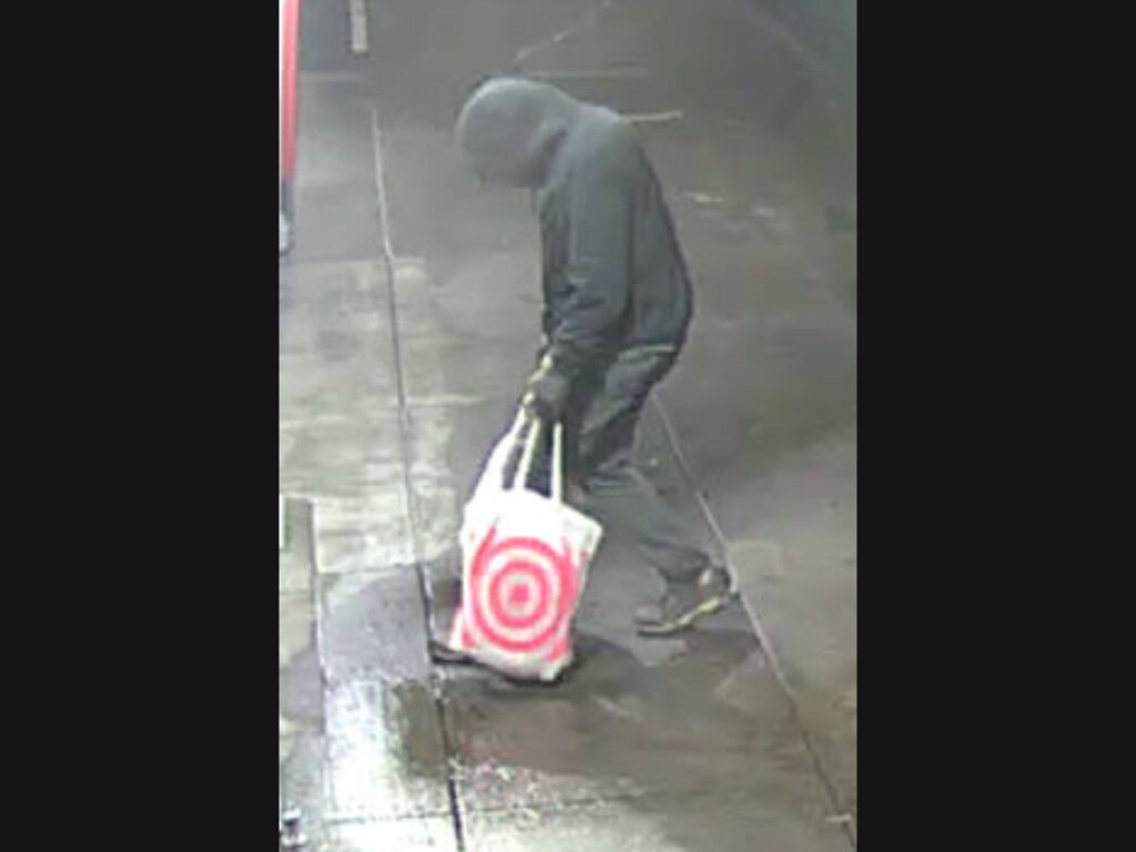 bank arson suspect carrying a target bag