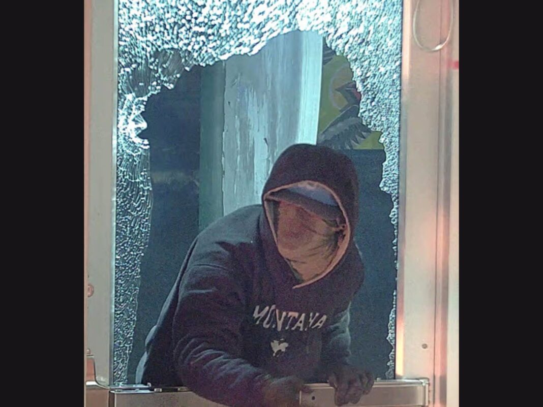 bank arson suspect looking out a window