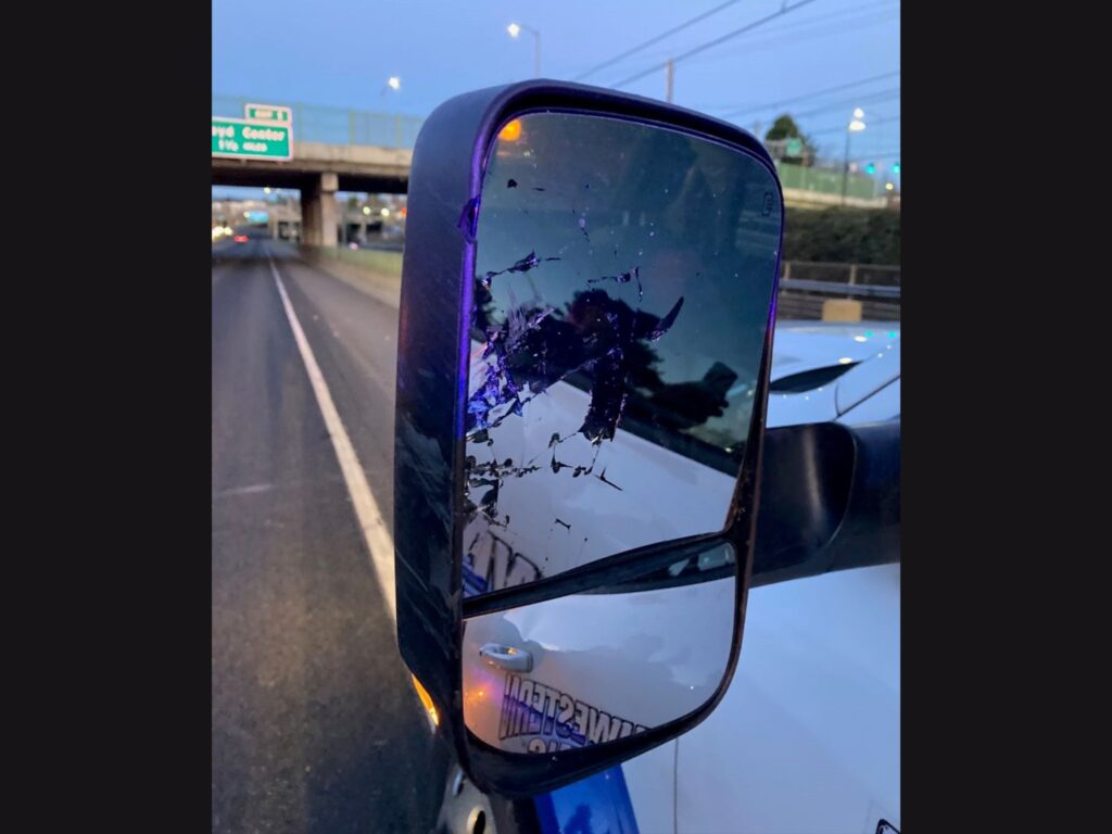 damaged rear view mirror of tow truck