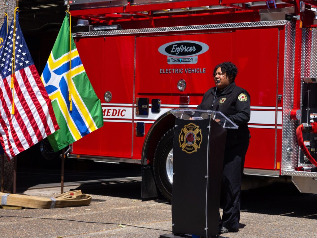 Sara Boone speaking at a event unveiling PFR's first ev engine