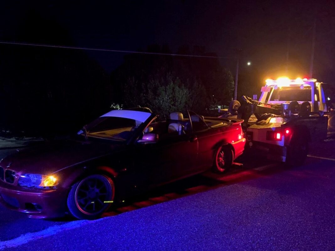 BMW being towed after street racing mission success