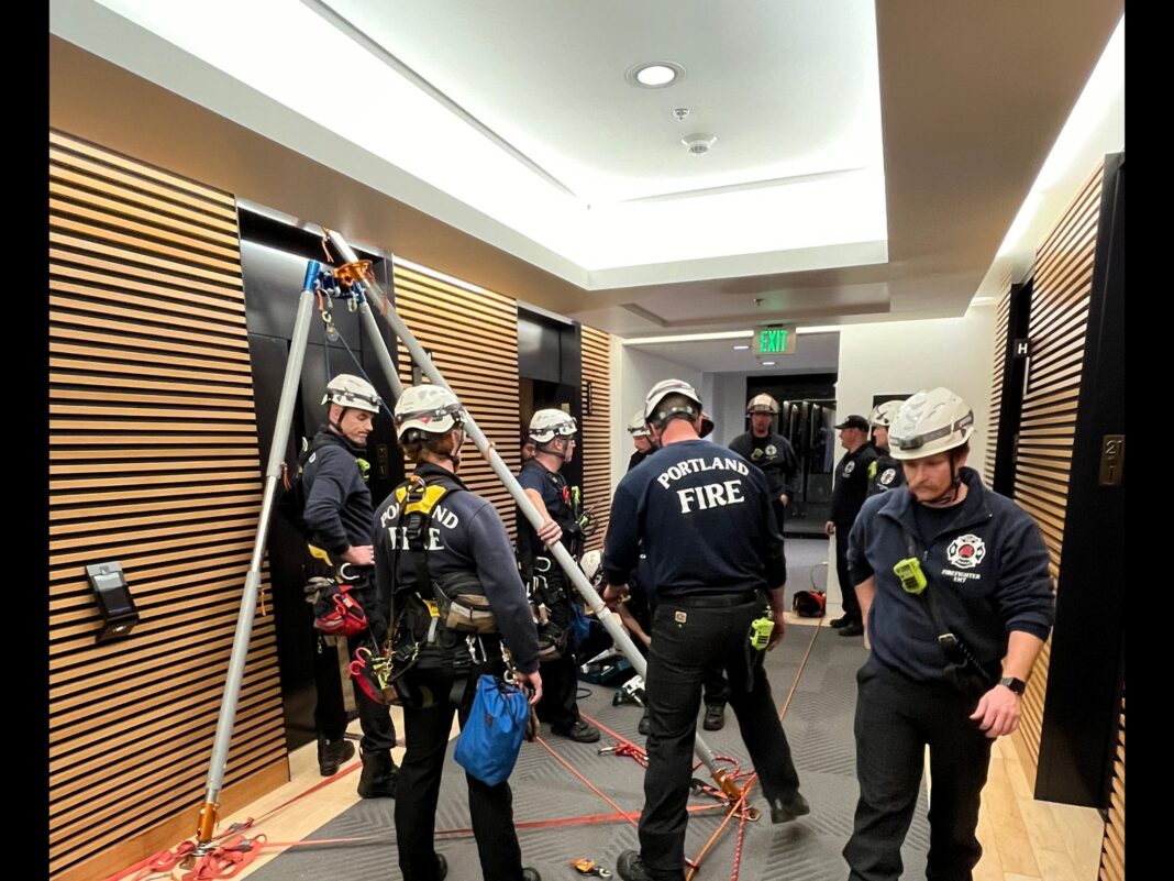 firefighters preparing to descend the elevator