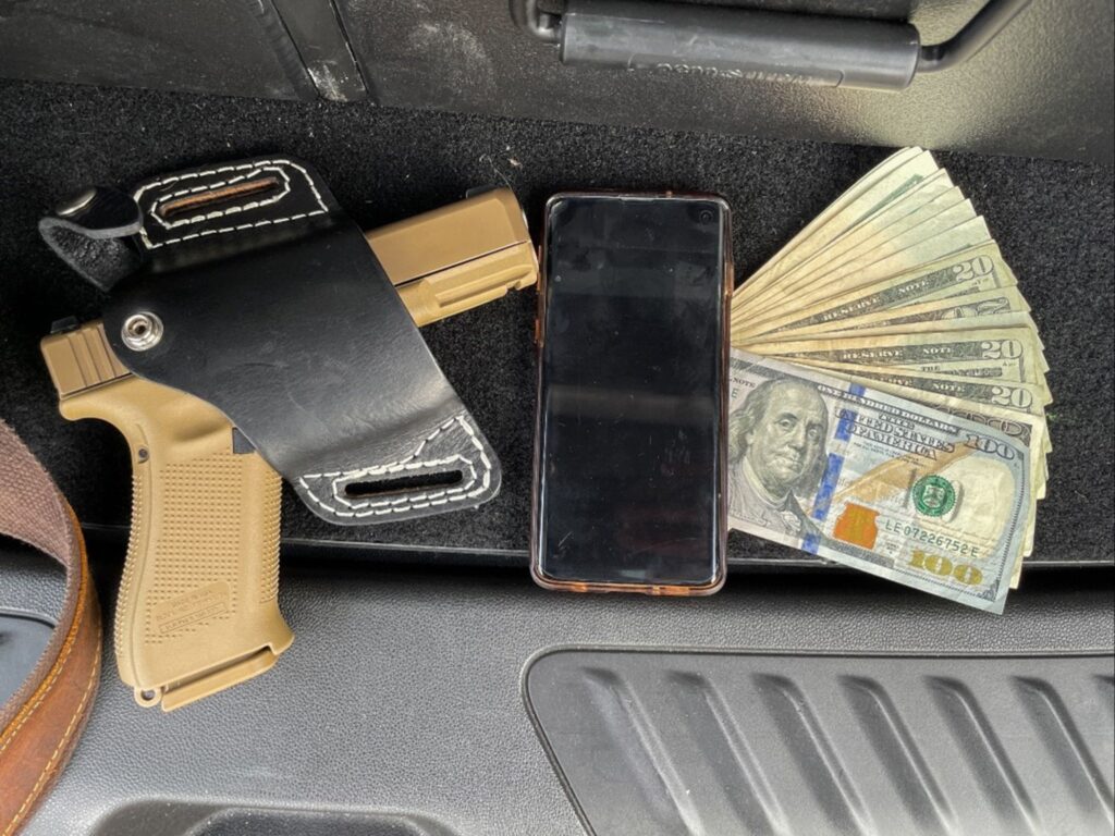 gun, phone, money seized during operation