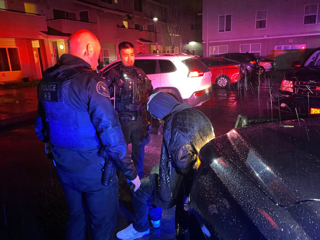 officers questioning a suspect during the stolen vehicle operation