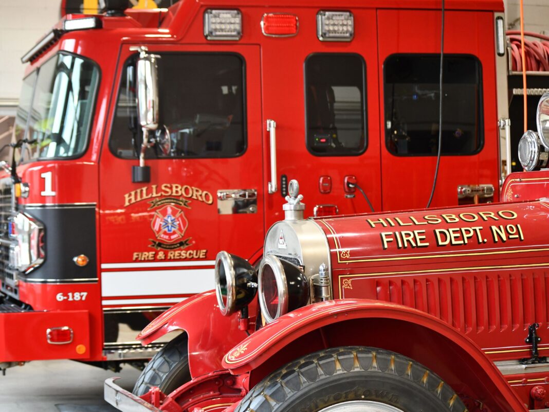 new fire engine and oldest fire engine side by side 100 year anniversary