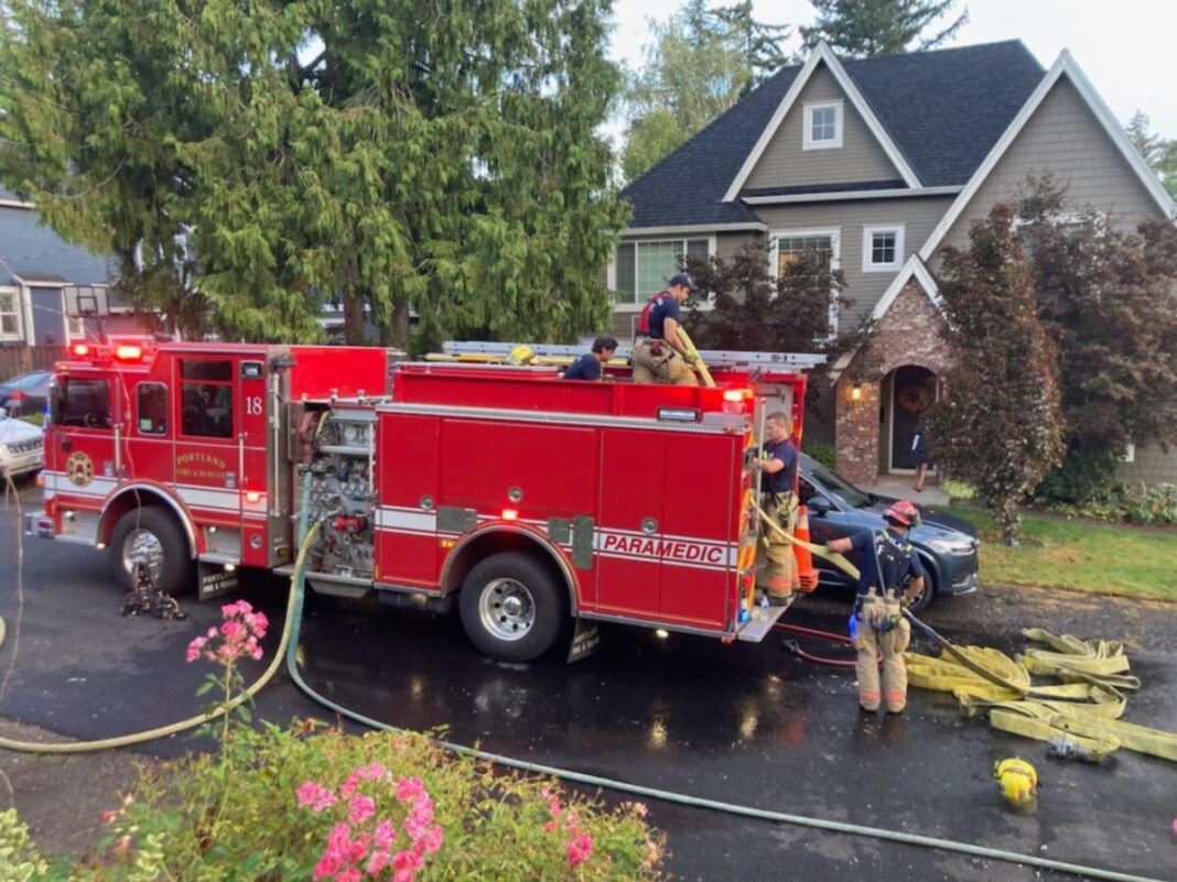 firefighters outside of one of the homes that suffered from a battery fire